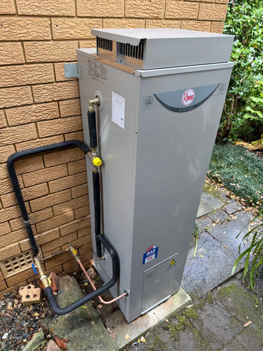Rheem 4 Star gas storage hot water replacement beside a brick wall