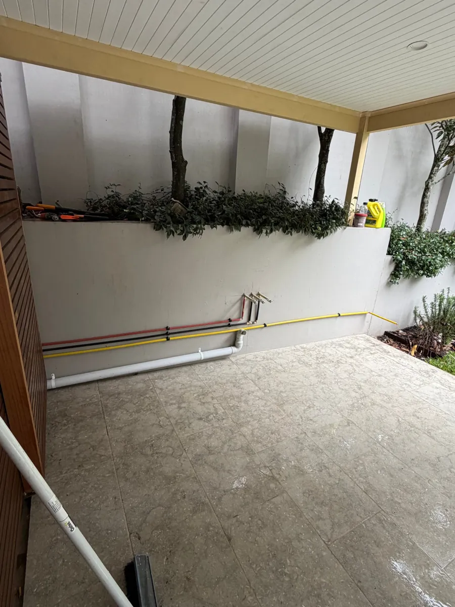 Outdoor kitchen water, gas and waste pipework rough-in along a patio wall