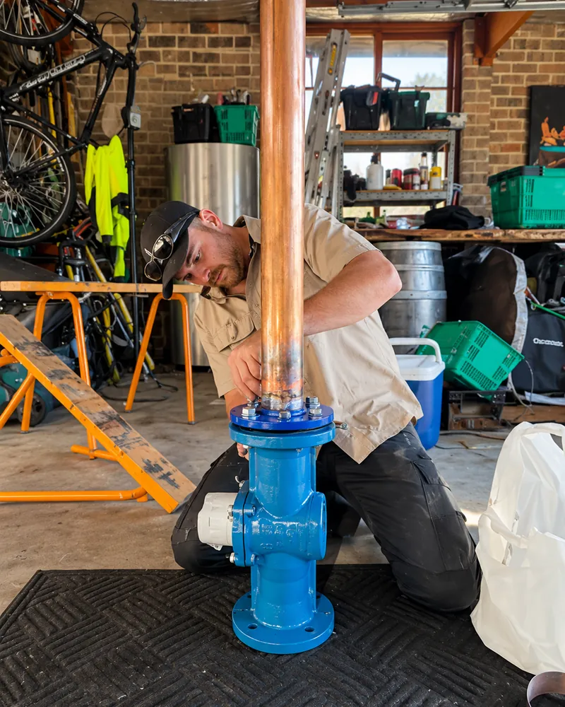 Daniel fitting a new valve to a copper water line