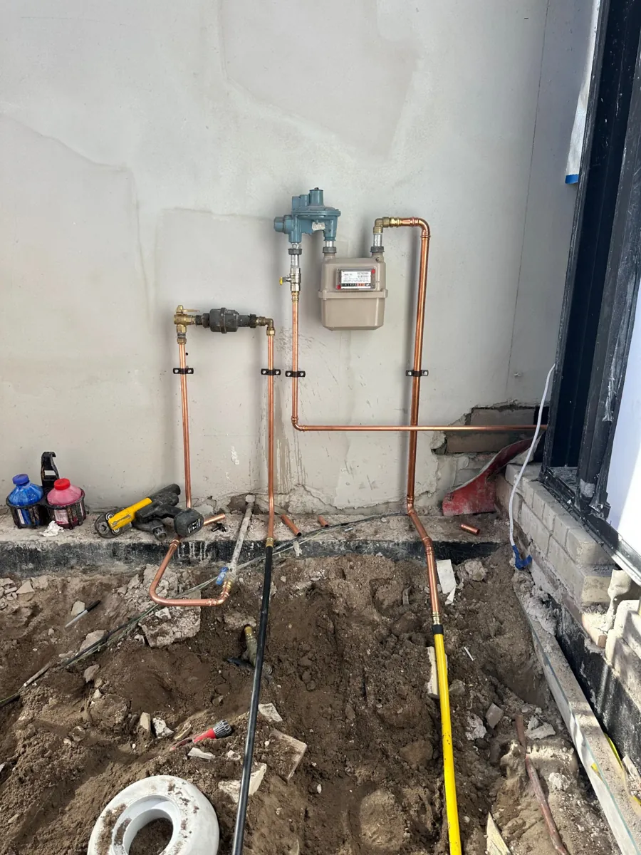 Gas meter and regulator with copper pipework and an exposed gas line